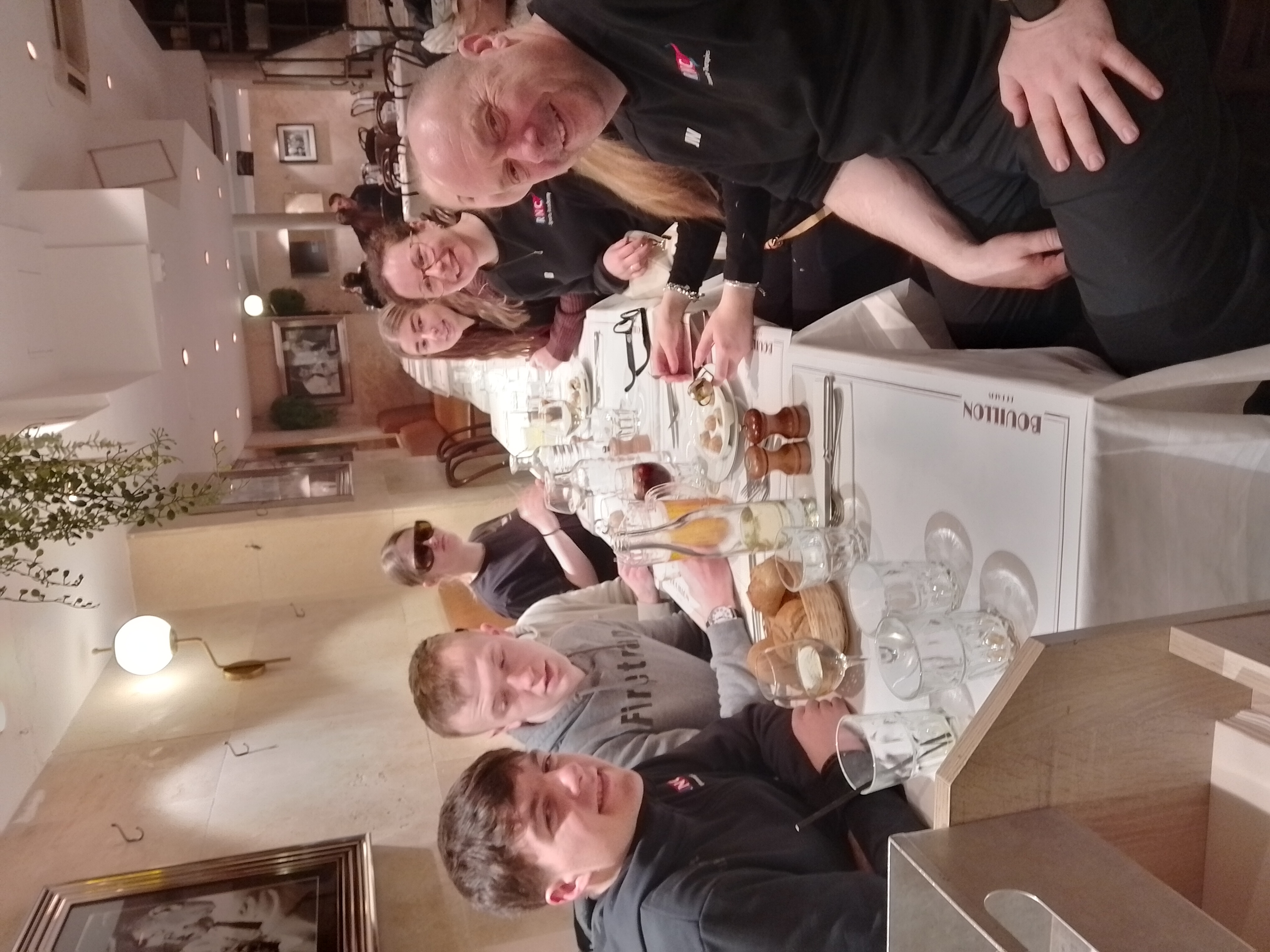 the group sitting at a long rectangular table in the restaurant